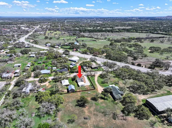 an aerial view of residential houses with city view