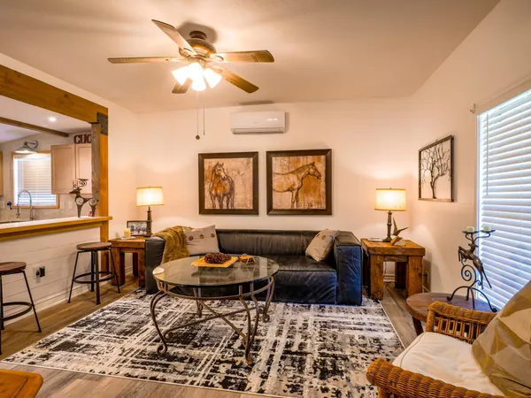a living room with furniture and a chandelier