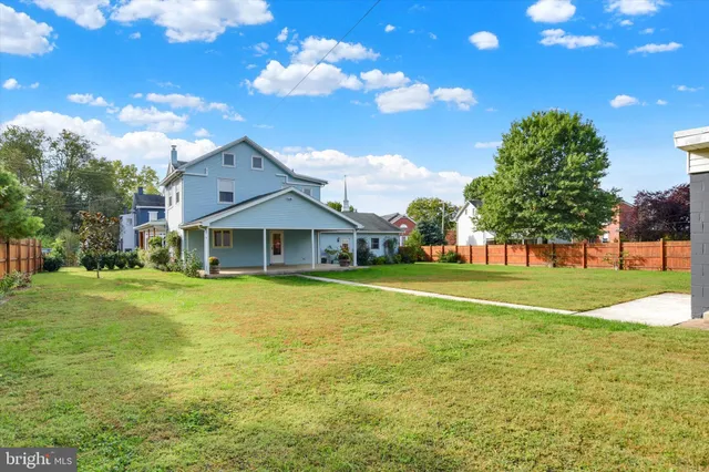 a front view of a house with a big yard
