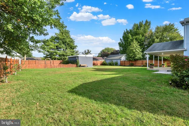 a view of a house with a backyard porch and sitting area