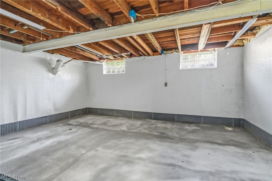 4449 18th Street Northwest Canton, OH 44708 - Photo 20 of 25 Unfinished basement with exposed ceiling joists and concrete flooring