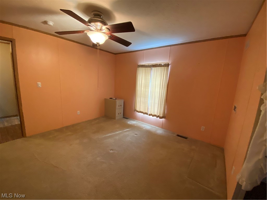 85 Rains Circle Zanesville, OH 43701 - Photo 11 of 15 Unfurnished room featuring crown molding, light colored carpet, and ceiling fan