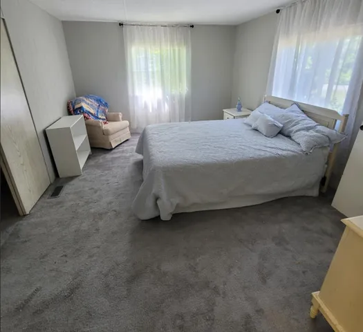 a bedroom with a bed and window