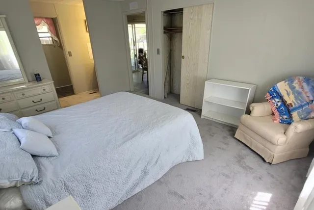 a bedroom with a bed and a couch