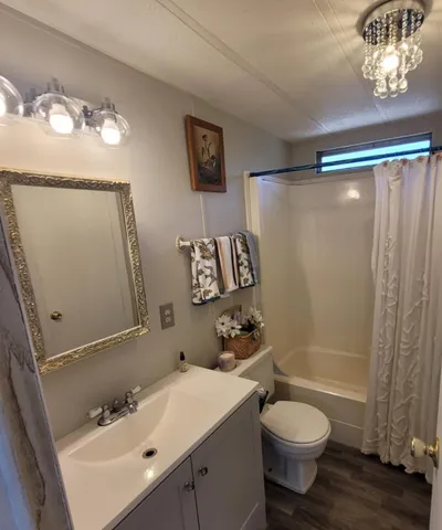 a bathroom with a sink mirror toilet and shower