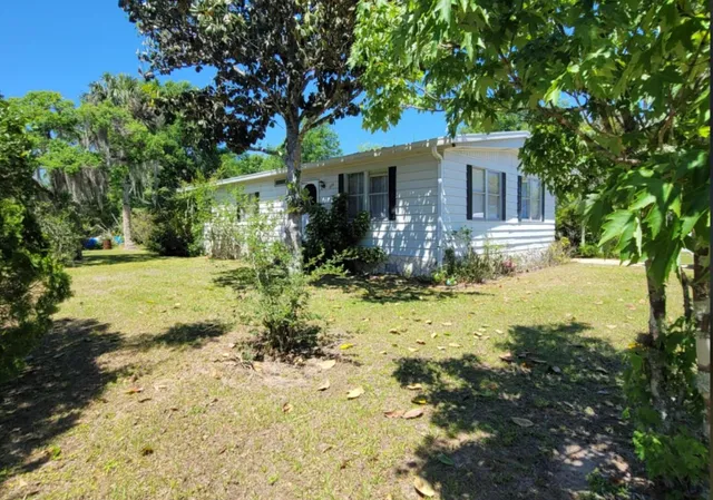 a view of house with yard