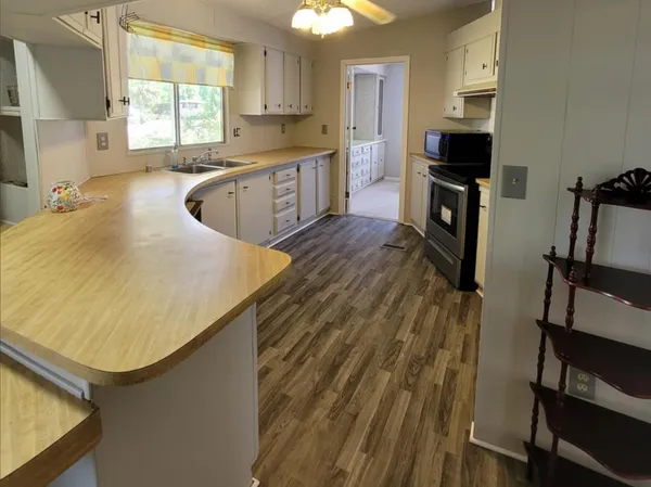 a kitchen with a sink appliances and cabinets