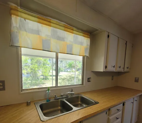 a kitchen that has a sink and a window
