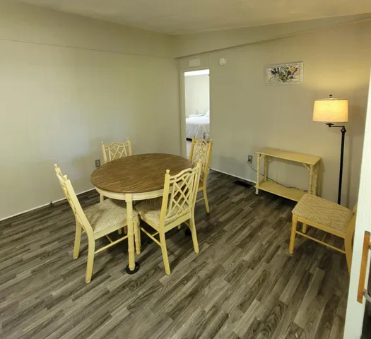 a dining room with furniture and wooden floor