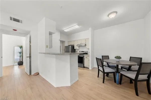 a view of a dining room with furniture and wooden floor