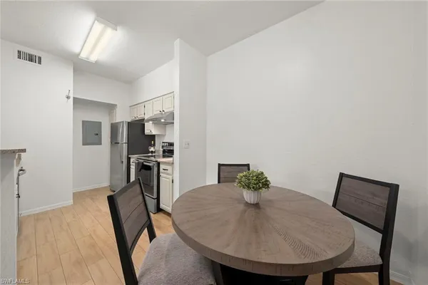 a view of a dining room with furniture and wooden floor