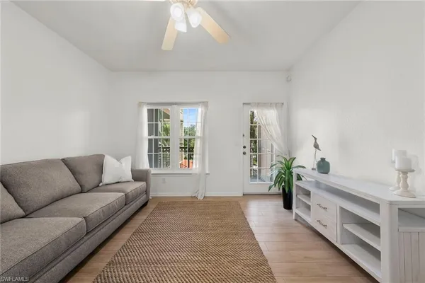 a living room with furniture and a potted plant