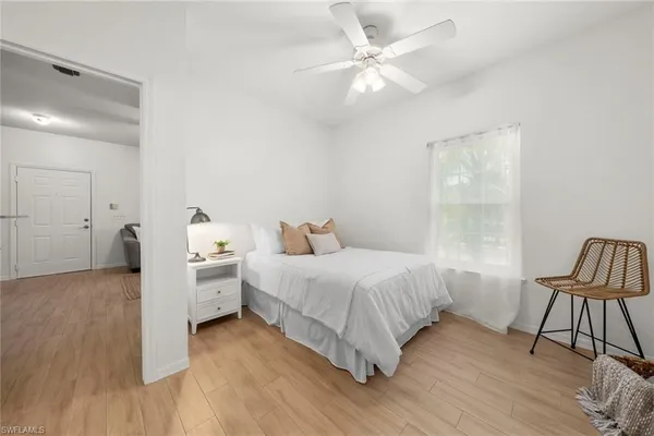 a bedroom with a bed and a chair