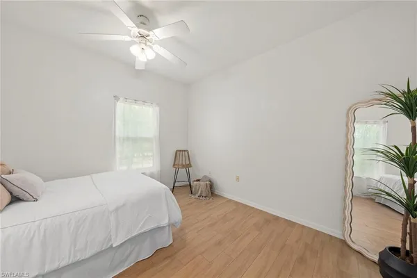 a bedroom with a bed with wooden floor