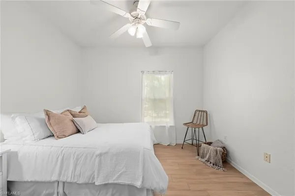 a bedroom with a bed and a chair