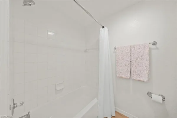 a bathroom with a bathtub and shower