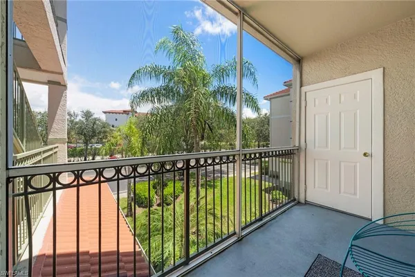 a balcony view with a large window and wooden floor