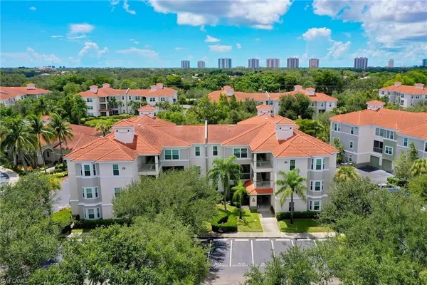 an aerial view of lake and residential houses with outdoor space