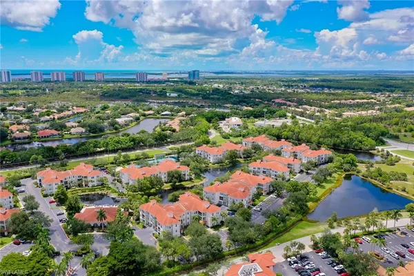 a view of a garden with lawn chairs under an umbrella
