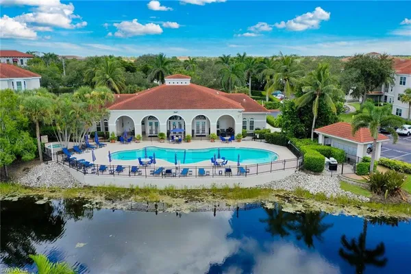 an aerial view of a house with swimming pool patio and outdoor seating