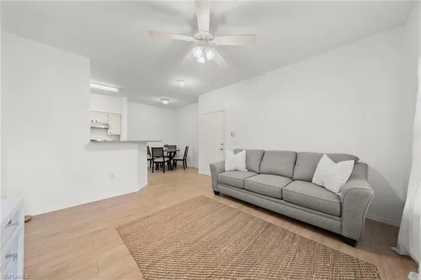 a living room with furniture and kitchen view