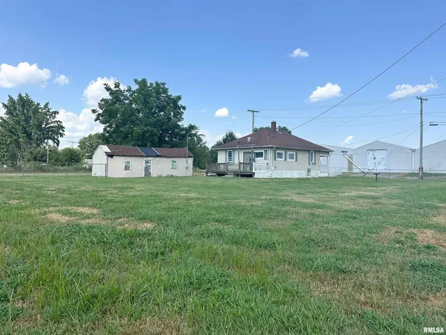 a view of a house with a yard and a large window