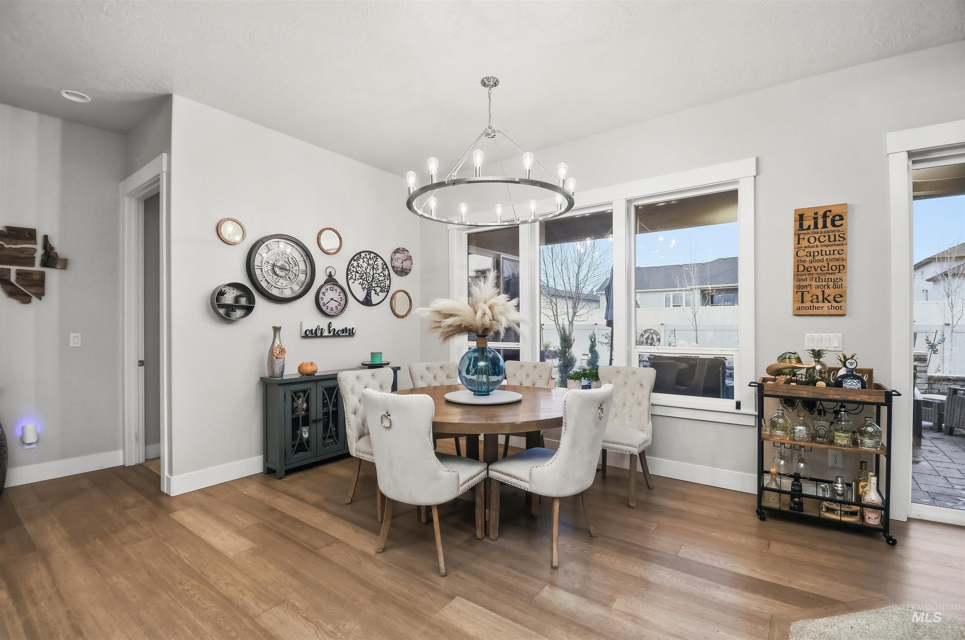 12174 West Lacerta Street Star, ID 83669 - Photo 13 of 49 Dining room with wood finished floors and a chandelier