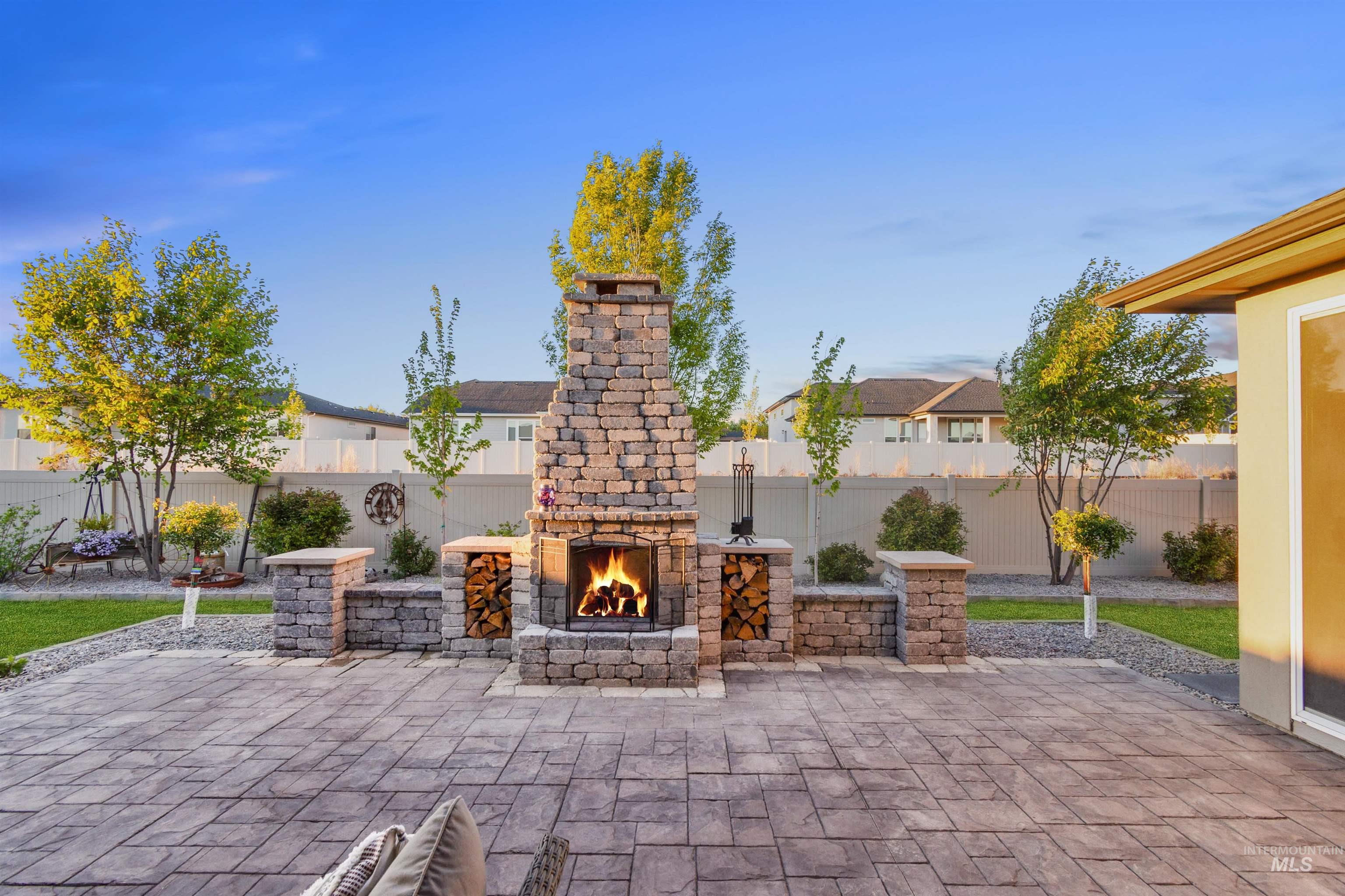 12174 West Lacerta Street Star, ID 83669 - Photo 2 of 49 Fenced backyard with a patio area and an outdoor stone fireplace