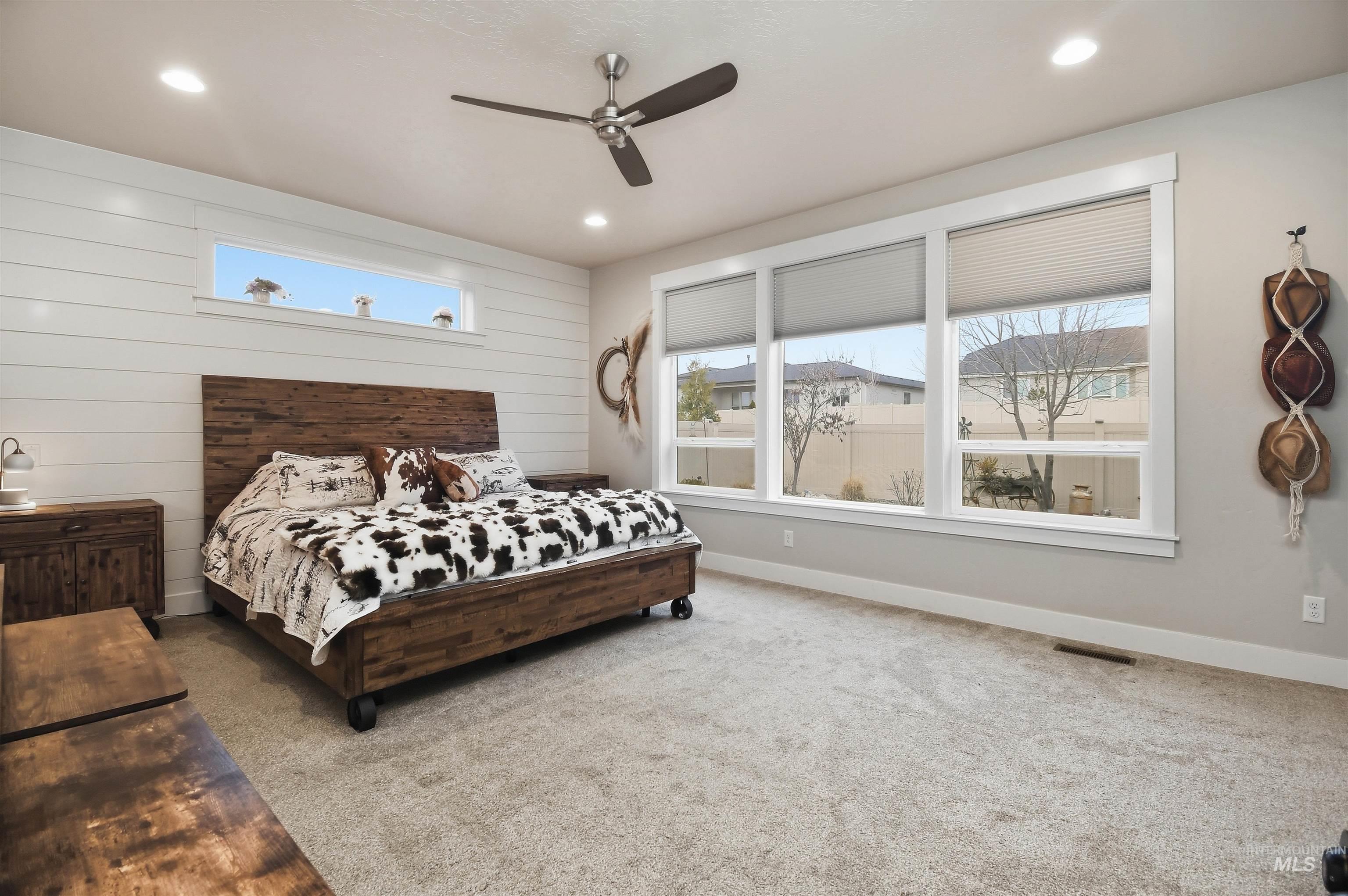 12174 West Lacerta Street Star, ID 83669 - Photo 21 of 49 Carpeted bedroom featuring a ceiling fan, wood walls, and recessed lighting