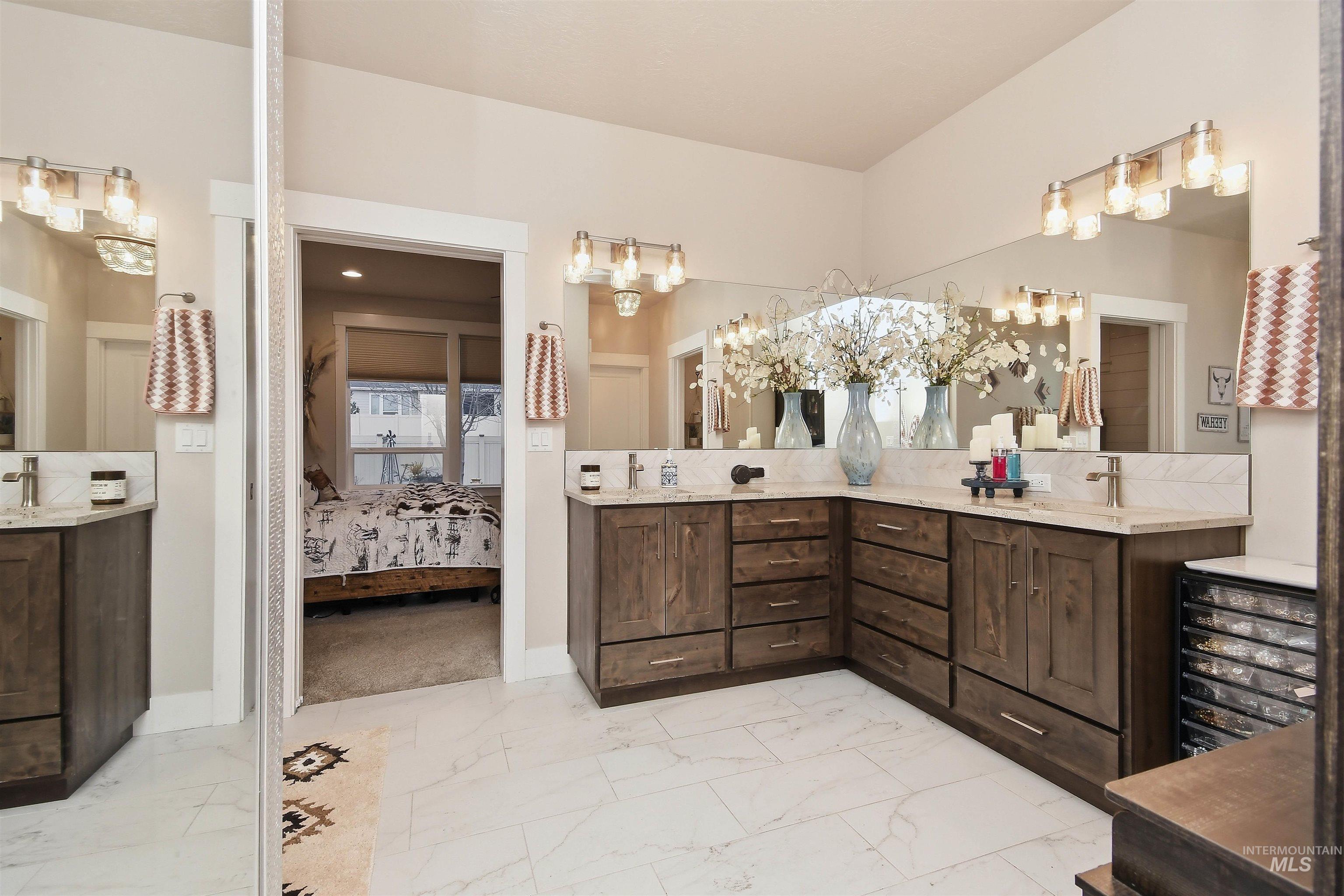 12174 West Lacerta Street Star, ID 83669 - Photo 24 of 49 Ensuite bathroom with double vanity and light marble finish flooring
