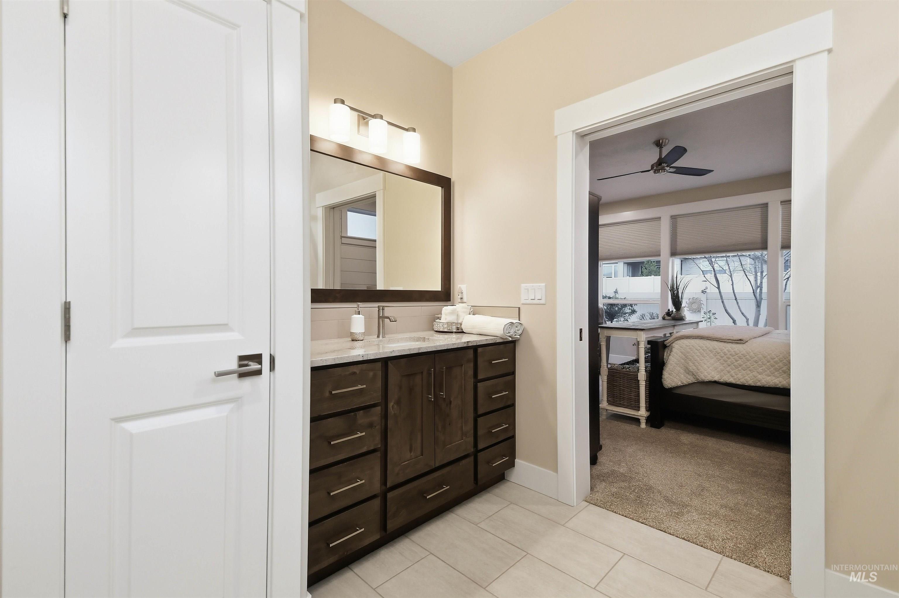 12174 West Lacerta Street Star, ID 83669 - Photo 33 of 49 Ensuite bathroom featuring vanity, light colored carpet, a ceiling fan, and light tile patterned flooring