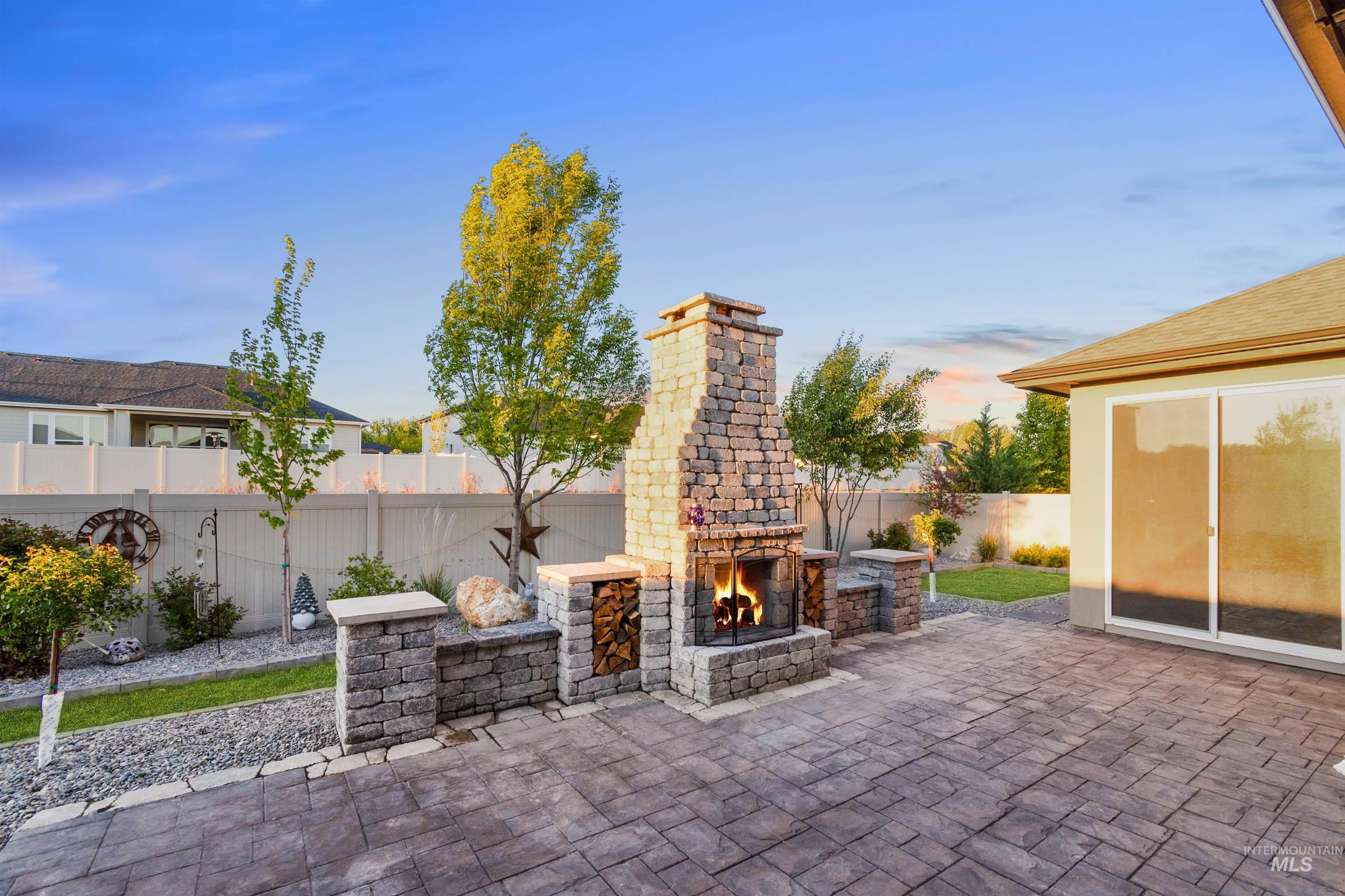 12174 West Lacerta Street Star, ID 83669 - Photo 37 of 49 Fenced backyard with a patio area and an outdoor stone fireplace