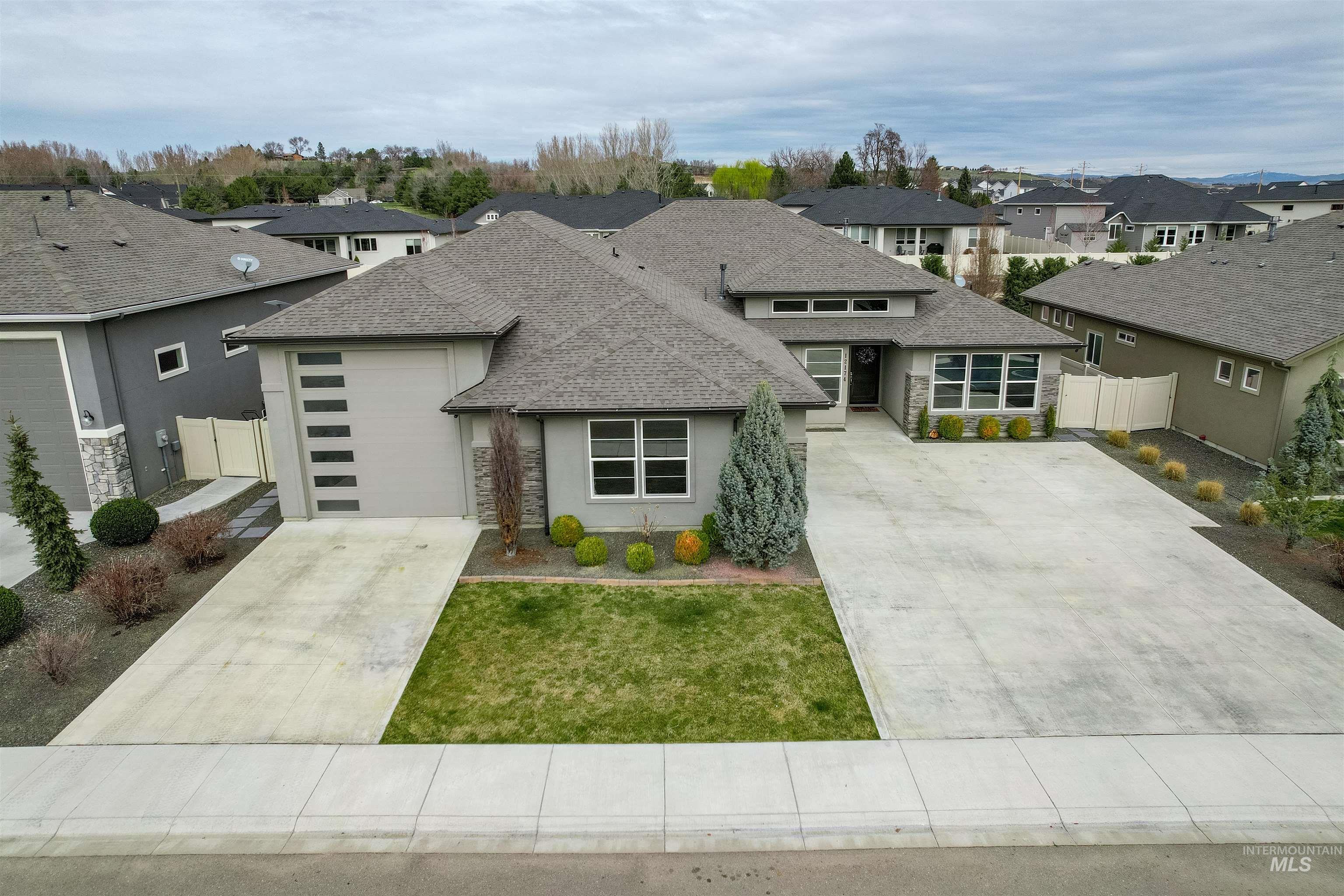 12174 West Lacerta Street Star, ID 83669 - Photo 43 of 49 Prairie-style home with stone siding, stucco siding, a residential view, and a shingled roof