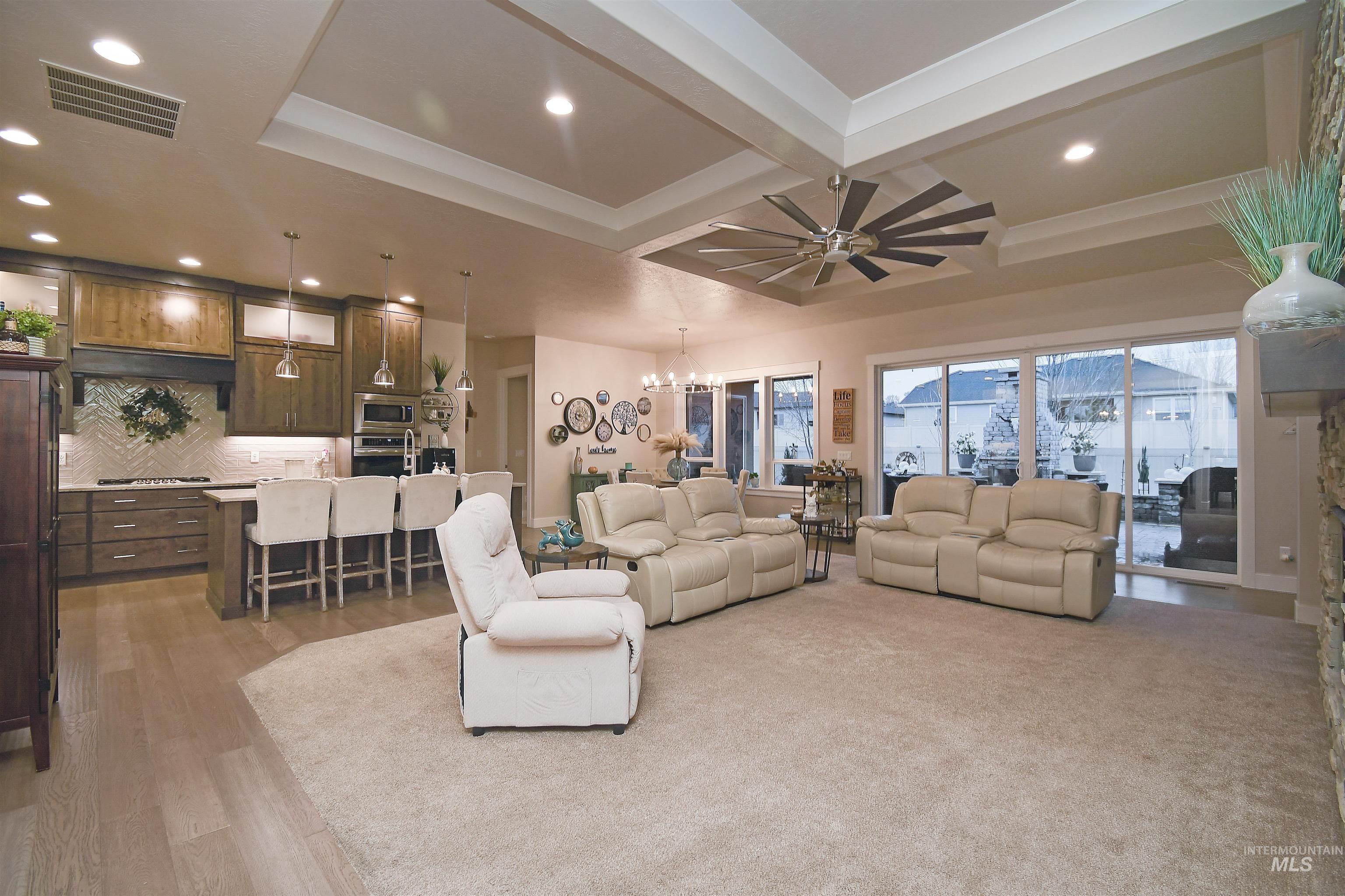 12174 West Lacerta Street Star, ID 83669 - Photo 8 of 49 Living room featuring suspended lighting, coffered ceiling, and light wood-style floors