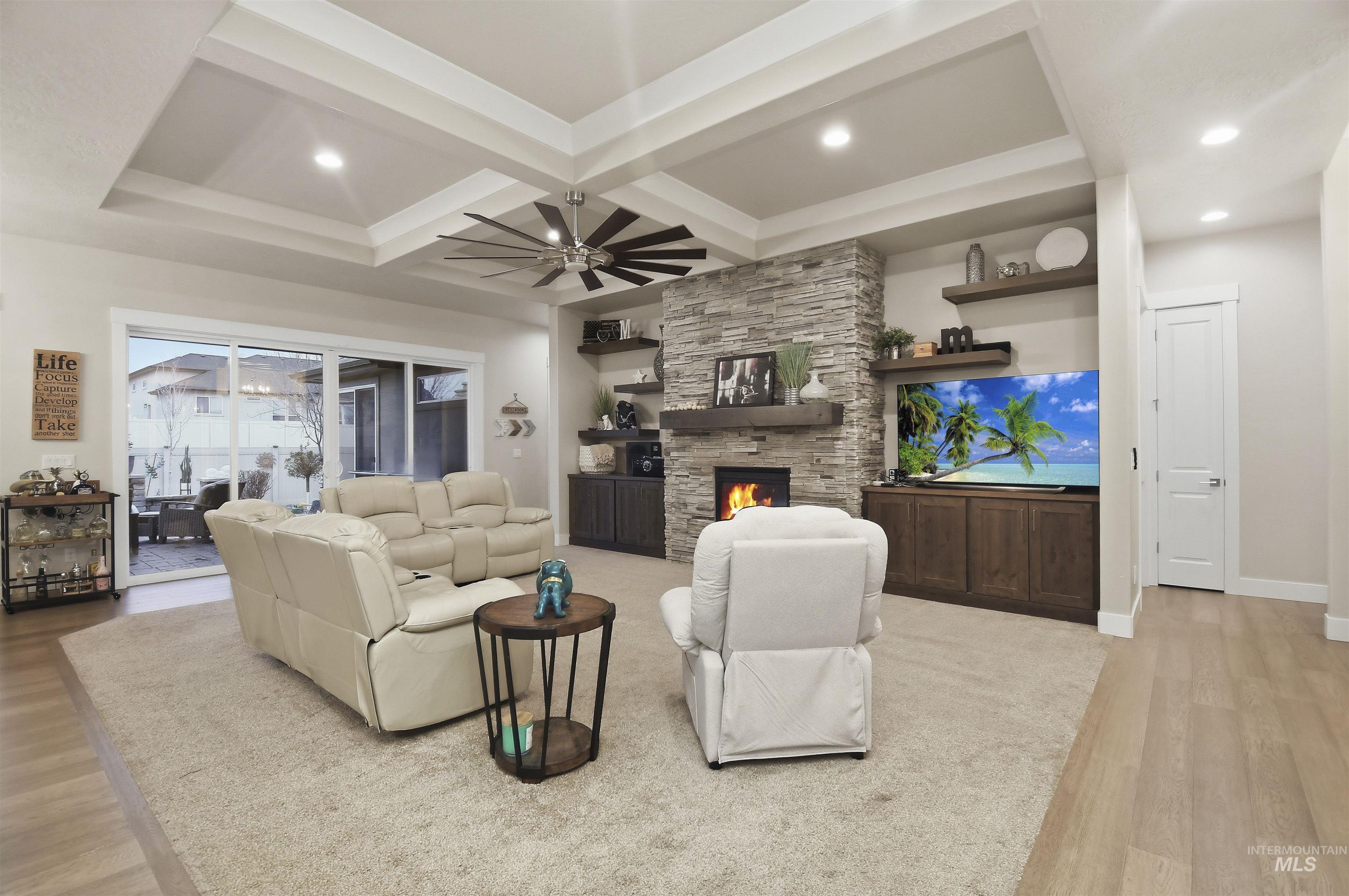 12174 West Lacerta Street Star, ID 83669 - Photo 9 of 49 Living room featuring coffered ceiling, ceiling fan, light wood finished floors, a stone fireplace, and recessed lighting