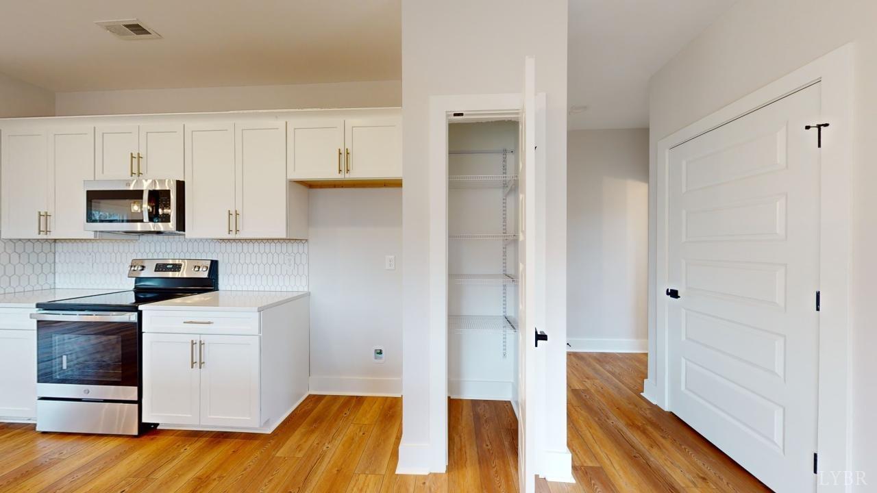 201 Allure Drive Rustburg, VA 24588 - Photo 11 of 46 a kitchen with a sink and a refrigerator