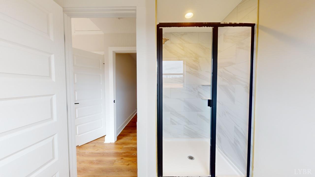 201 Allure Drive Rustburg, VA 24588 - Photo 23 of 46 a bathroom with a glass shower door