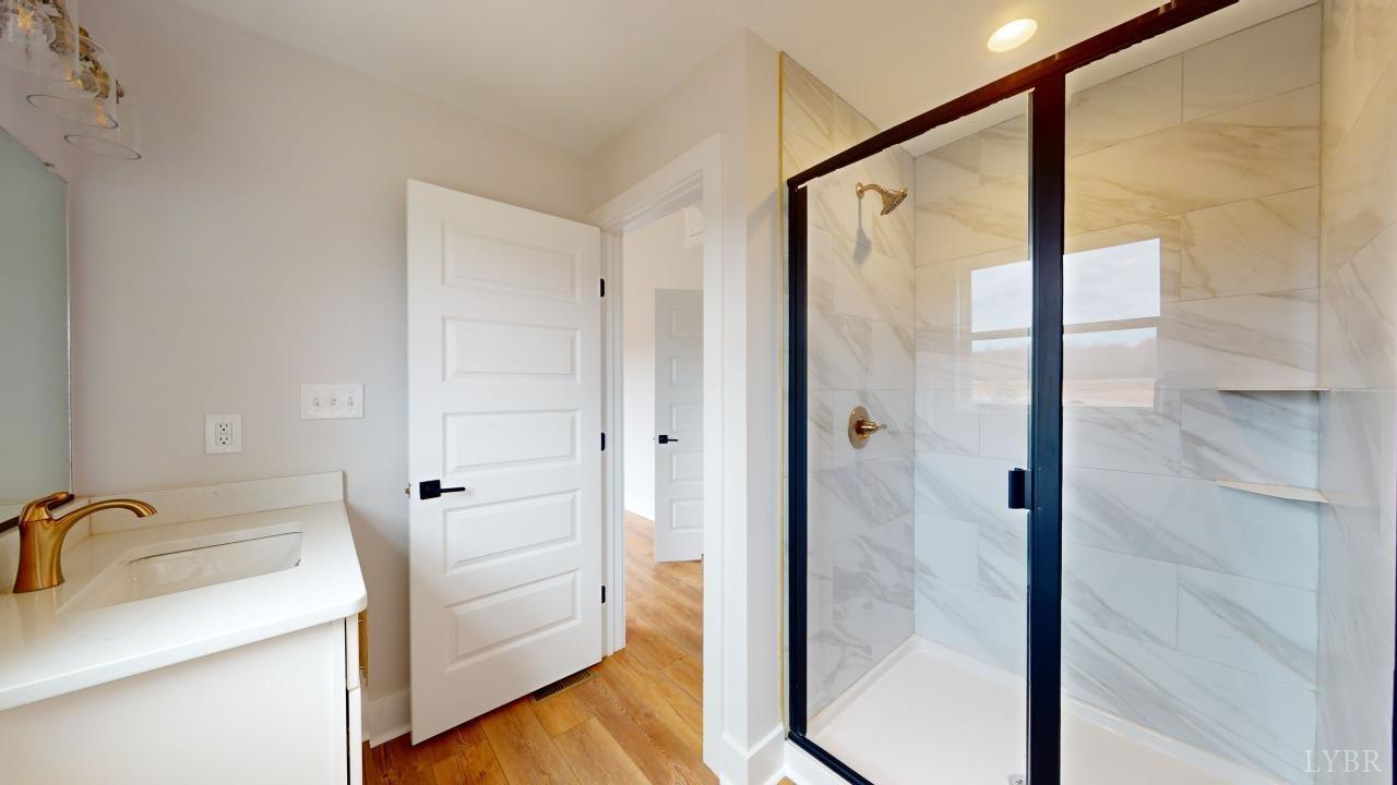 201 Allure Drive Rustburg, VA 24588 - Photo 24 of 46 a bathroom with a sink and a glass door shower