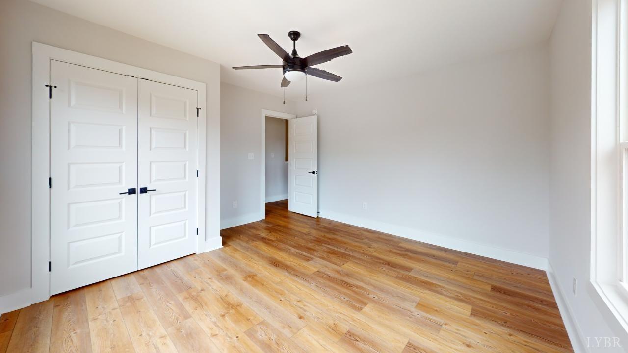201 Allure Drive Rustburg, VA 24588 - Photo 37 of 46 a view of a livingroom with a hardwood floor and a ceiling fan