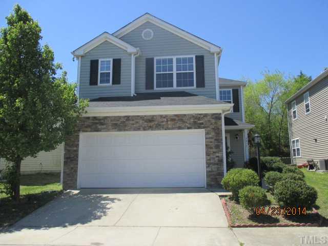 4817 Tommans Trail Raleigh, NC 27616 - Photo 1 of 7 a front view of a house with a yard and garage