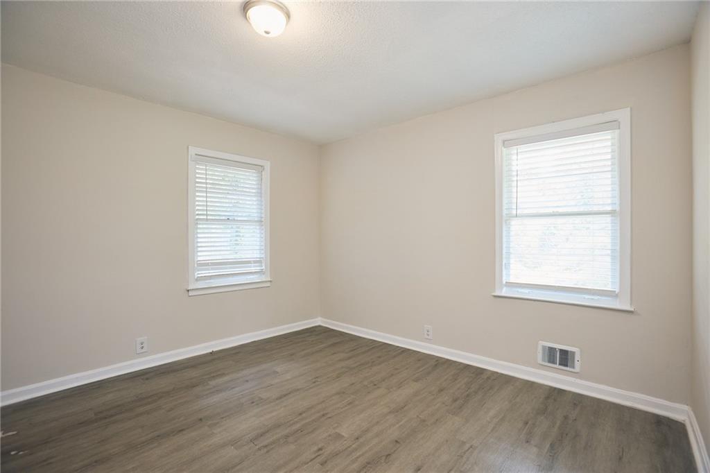 2058 River Road Ellenwood, GA 30294 - Photo 11 of 14 an empty room with wooden floor and windows