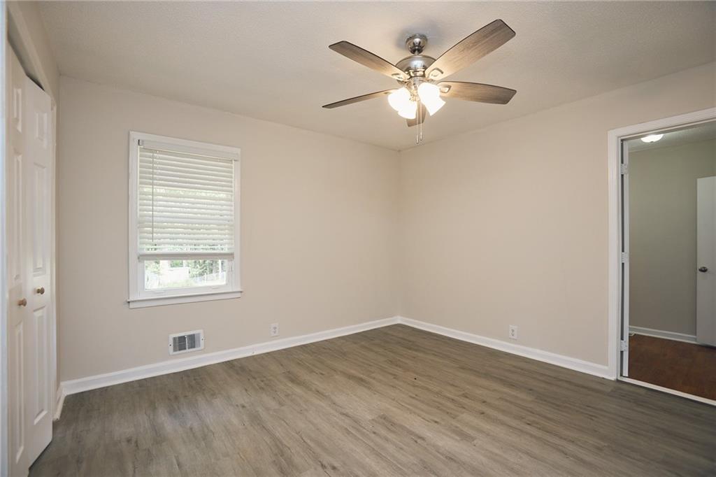 2058 River Road Ellenwood, GA 30294 - Photo 12 of 14 an empty room with wooden floor and windows