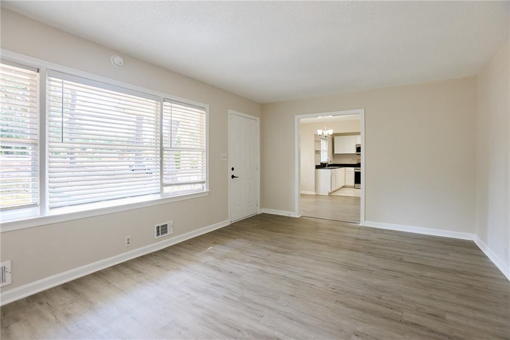 2058 River Road Ellenwood, GA 30294 - Photo 2 of 14 a view of an empty room with a window and wooden floor
