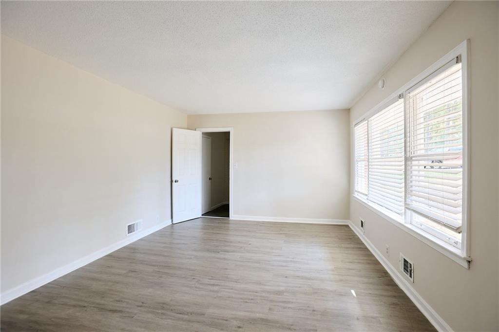2058 River Road Ellenwood, GA 30294 - Photo 8 of 14 a view of an empty room with wooden floor and a window