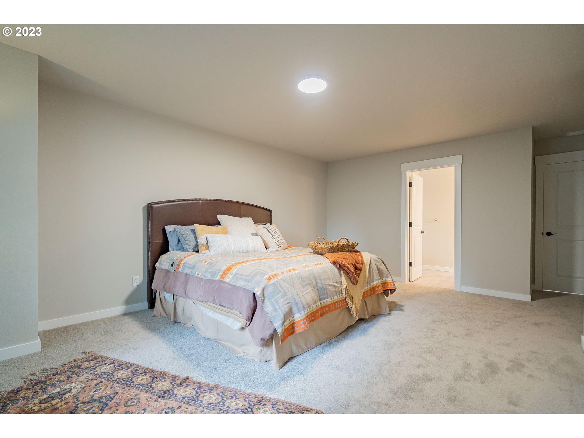 7111 South 13th Street Ridgefield, WA 98642 - Photo 14 of 33 a bed sitting in a bedroom next to a window
