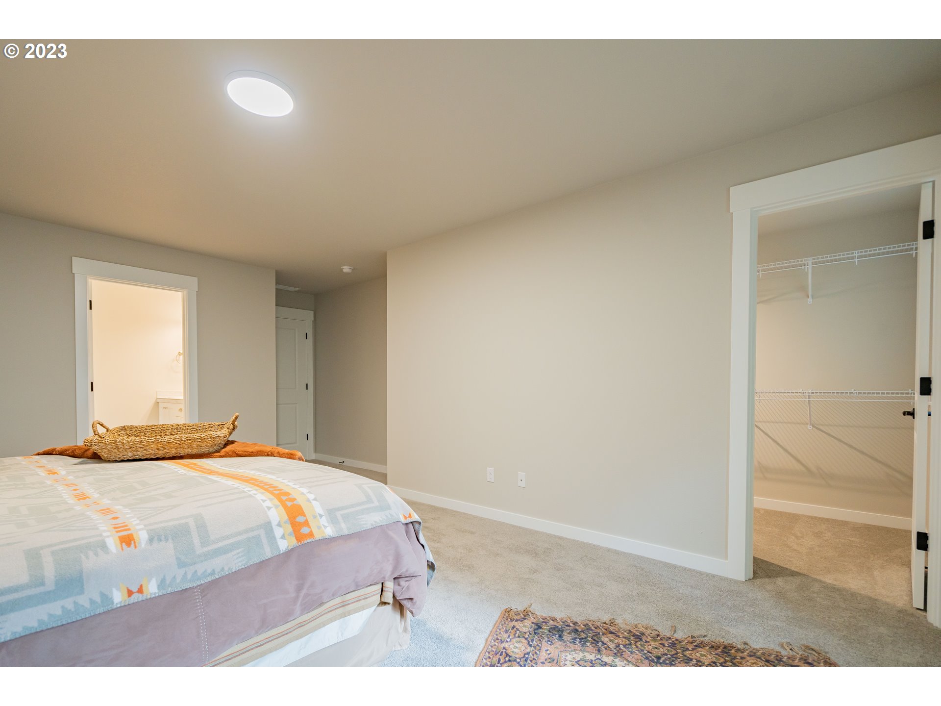 7111 South 13th Street Ridgefield, WA 98642 - Photo 15 of 33 a bedroom with a bed and a cabinets