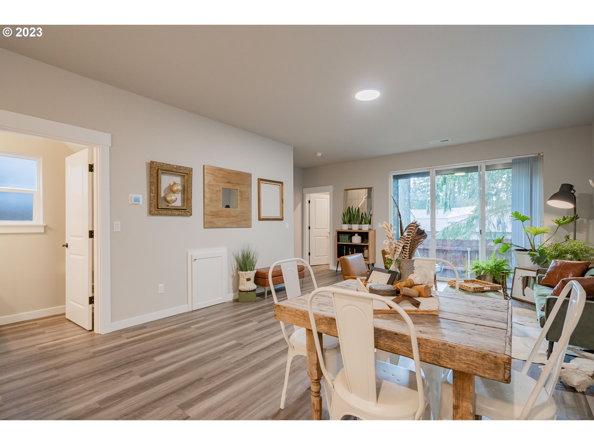 7111 South 13th Street Ridgefield, WA 98642 - Photo 6 of 33 a view of a dining room with furniture a potted plant and wooden floor