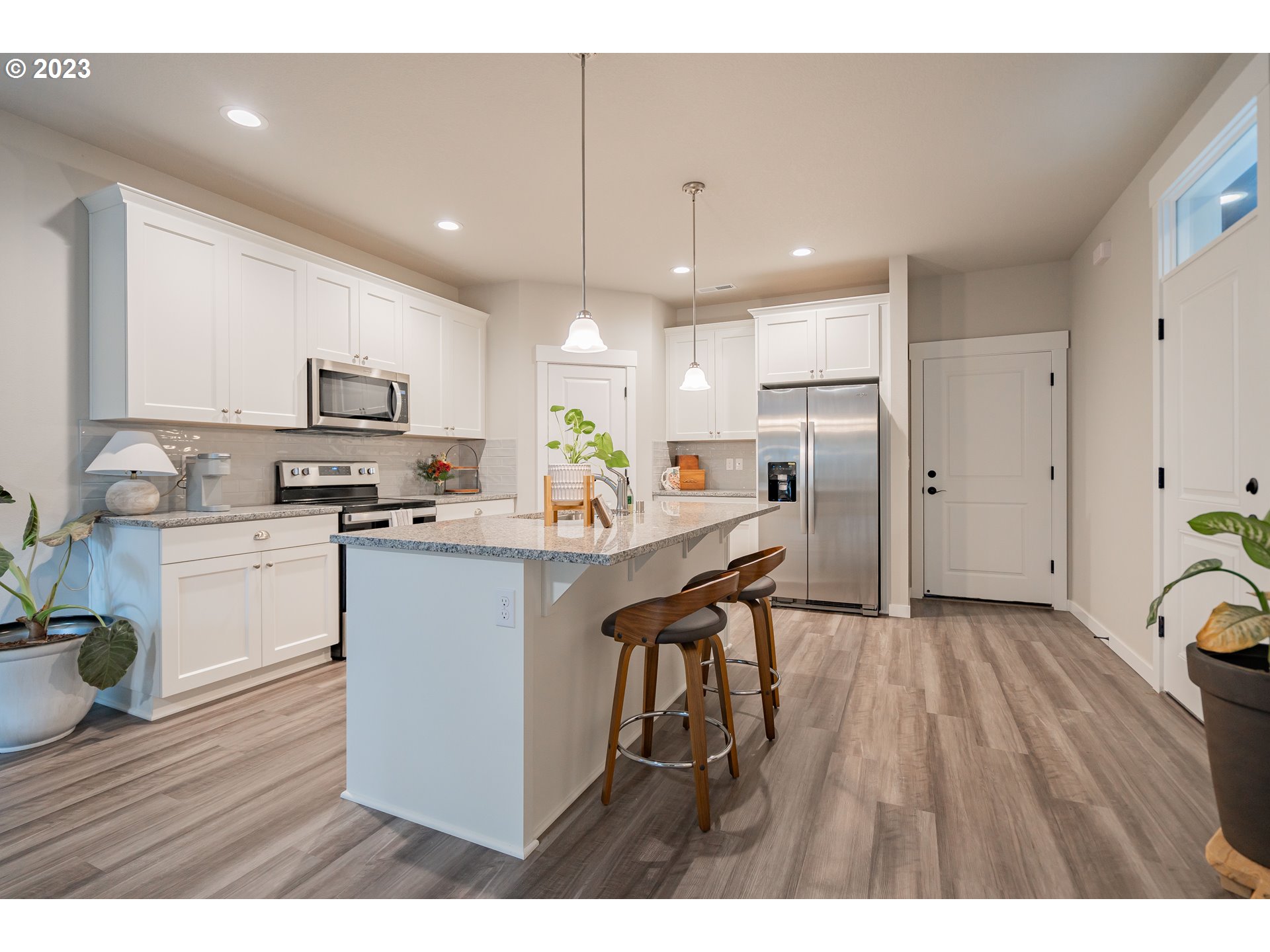 7111 South 13th Street Ridgefield, WA 98642 - Photo 7 of 33 a kitchen with a refrigerator a sink and cabinets