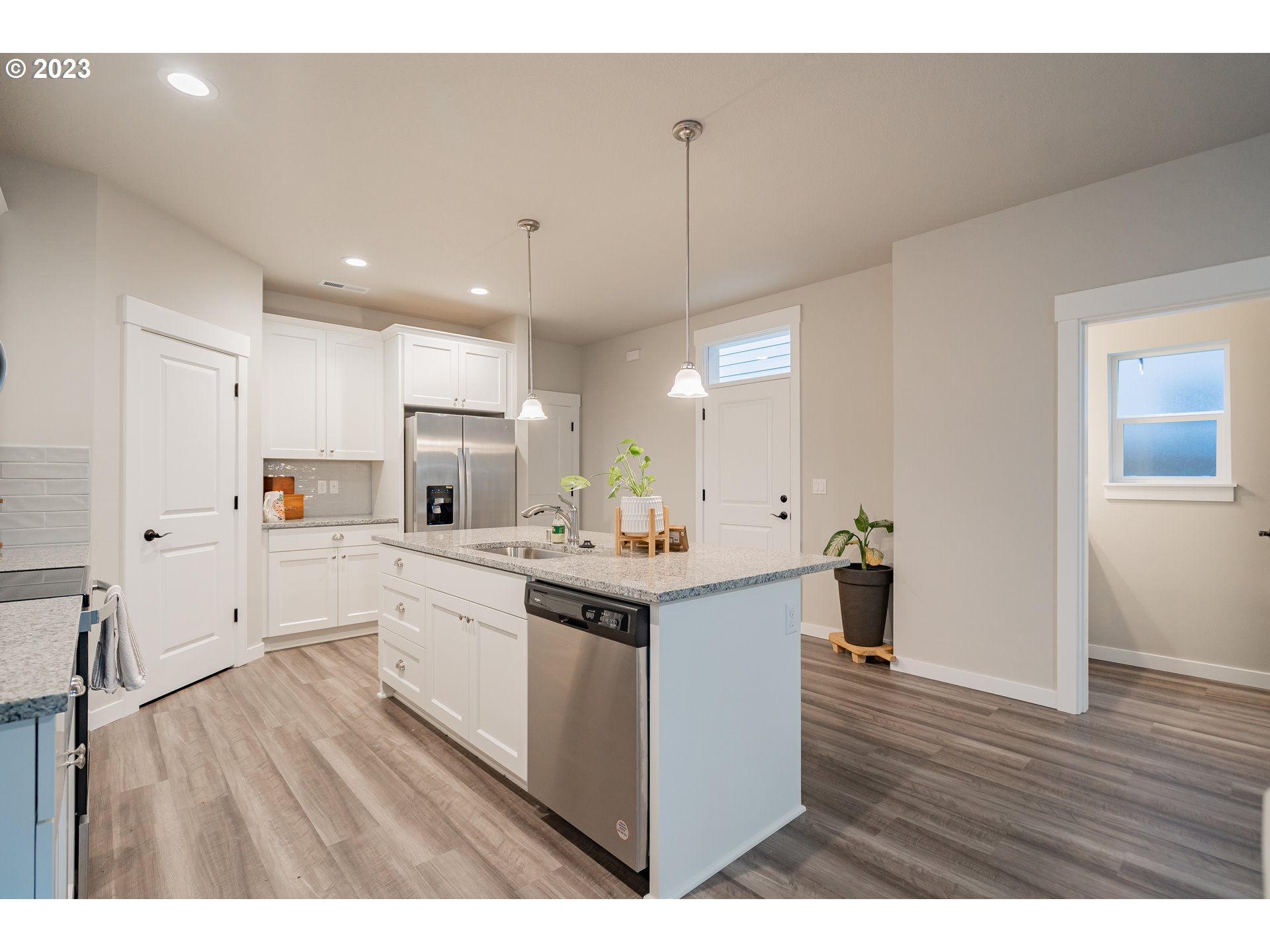 7111 South 13th Street Ridgefield, WA 98642 - Photo 9 of 33 a kitchen with kitchen island sink stove and white cabinets