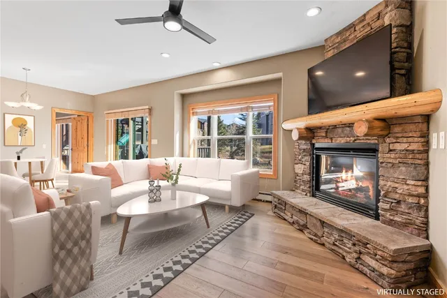 a living room with furniture a fireplace and a flat screen tv